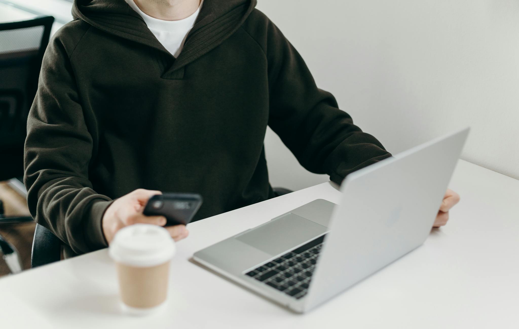 Man in Black Jacket Holding Black Smartphone