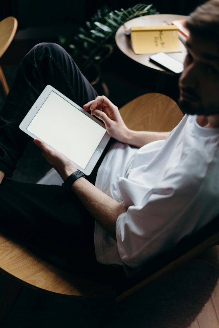 Man in White Button Up Shirt Holding White Tablet Computer